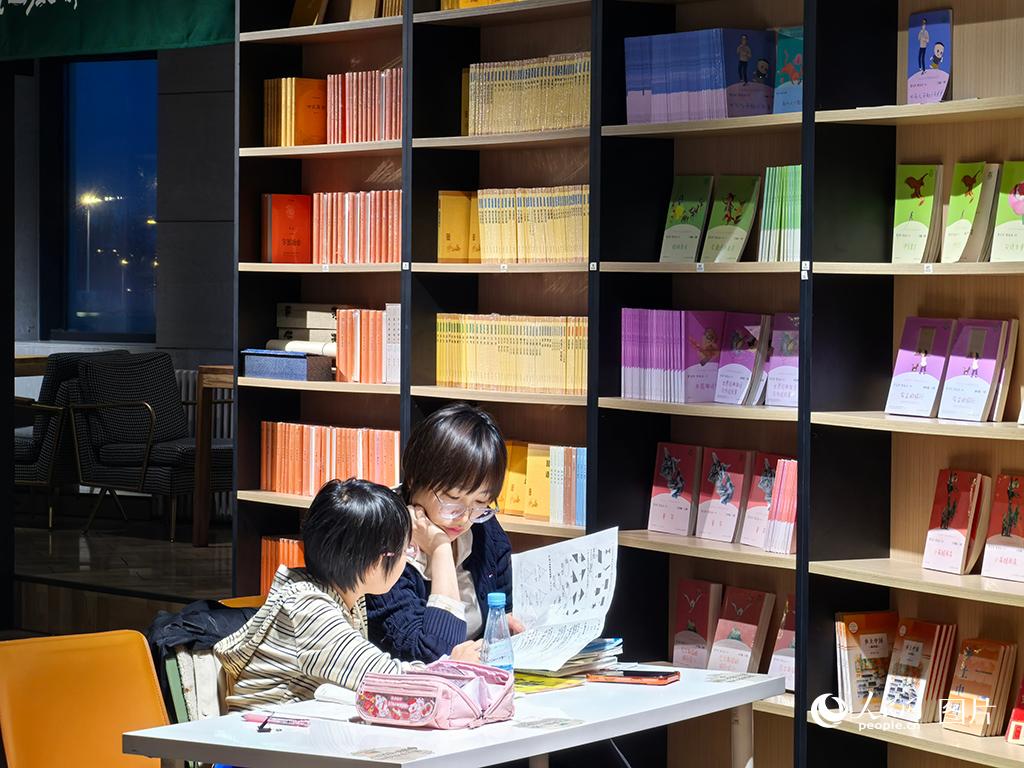 2026年4月17日晚，长春一商业综合体内，由吉林省新华书店集团打造的“夏书房”灯火温柔。这处曾获评“长春市我最喜欢的亲子阅读场所”的书香角落，温馨而僻静。书房一角，一位妈妈正陪孩子一起做作业、读书，轻声细语间，流淌着亲子共读的暖意。人民网记者 王海跃摄